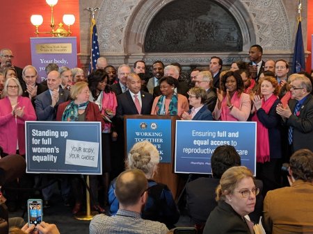 Members of the New York Senate conference celebrate the Reproductive Health Act that legalizes abortion up to birth, for any reason, in Albany, New York, on Jan. 22, 2019.