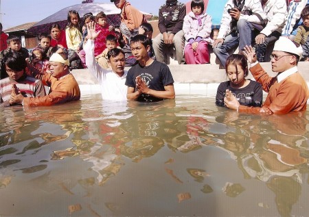 Members of the Rumai Palaung ethnic minority are being baptized by a pastor in the Shan state of Myanmar in 2013. 