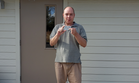 Jamie Shupe poses with his military identification card which now recognizes his actual biological sex, male.