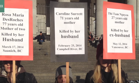 Protesters in favor of Vancouver Rape Relief hold signs outside the city government buildings in Vancouver.