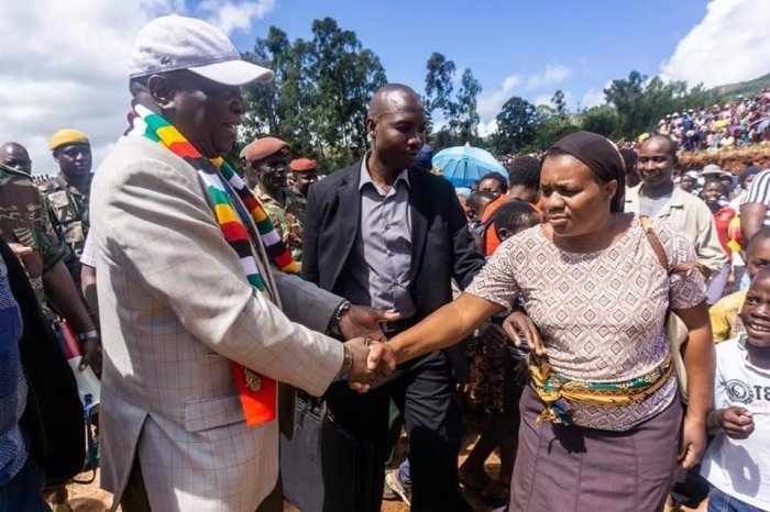 President Emmerson Dambudzo Mnangagwa (L) of Zimbabwe, greets citizens in the aftermath of Cyclone Idai on March 20, 2019.