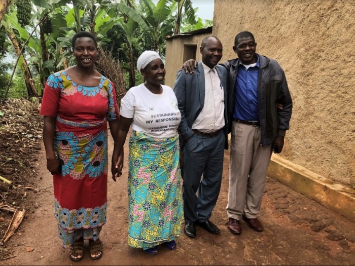 Callixte Karemangingo (middle right) and his wife, Marcella (left), pose for a photo with Andrew Birasa (right) and his wife, Madrine (middle left) at Birasa's home in the Nyamagabe district in Rwanda's Southern Province in February 2019. 