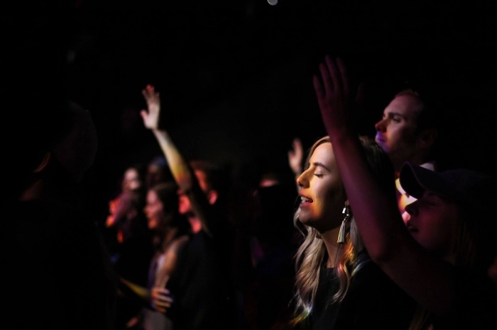 Young adults worship at The Porch, a young adult community founded by Watermark Community Church in Dallas, Texas. 