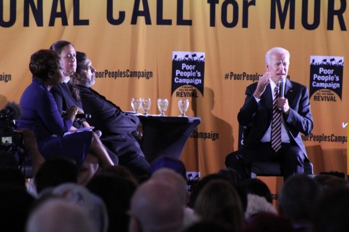 Former vice president and 2020 presidential hopeful Joe Biden (R) speaks at the Poor People's Campaign presidential forum at Trinity Washington University in Washington, D.C. on June 17, 2019. Situated to his right on the stage are Rev. William Barber, Rev. Liz Theoharis and MSNBC host Joy Reid.