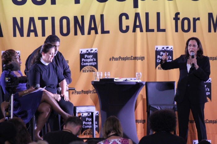 Presidential candidate Sen. Kamala Harris, D-Calif, speaks at the Poor People's Campaign Moral Action Congress in Washington, D.C. on June 17, 2019. To her right are moderators (from back to front) Bishop William Barber, Rev. Liz Theoharis and MSNBC host Joy Reid. 