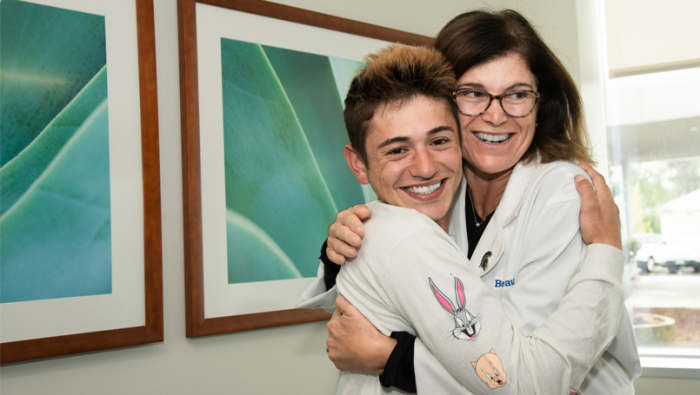 Michael Pruitt, 20 (L), hugs Dr. Angel Chudler.