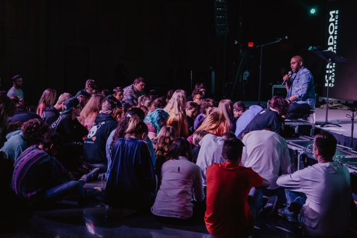 Pastor Kemtal Glasgow speaks to children during a Kingdom Youth Conference event 