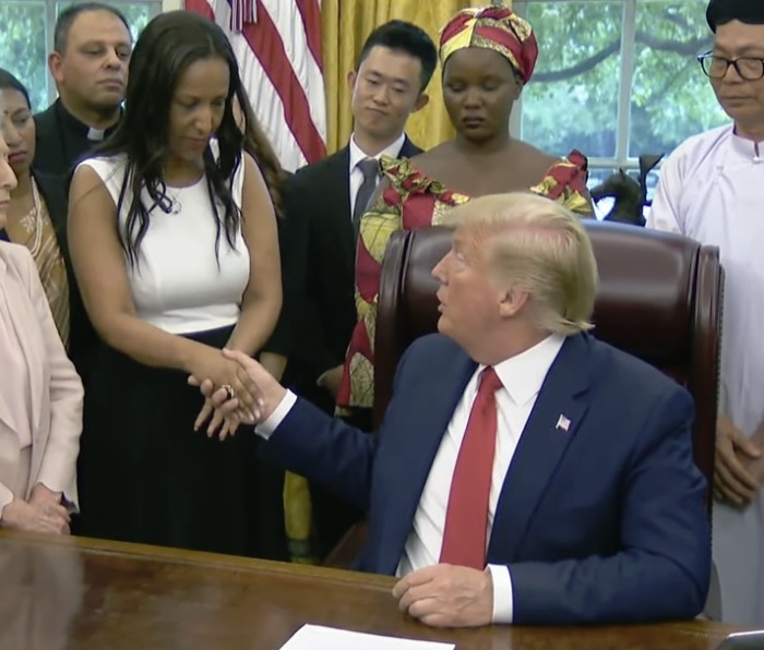 Eritrean Christian Helen Berhane shakes the hand of President Donald Trump during a meeting at the White House on July 17, 2019, in Washington, D.C. 