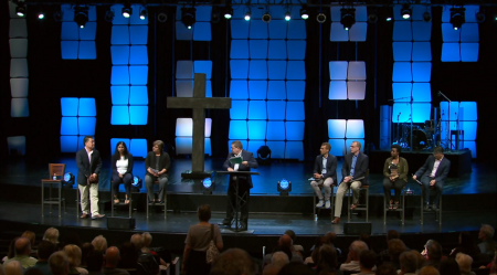 Eight of the nine members of Willow Creek Community Church's elder board promote unity at a Worship & Reflection Service. 