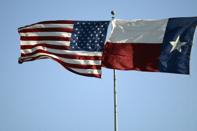 The U.S. and Texas flags wave in the wind Kyle Field in College Station, Texas, on Nov. 9, 2002. 