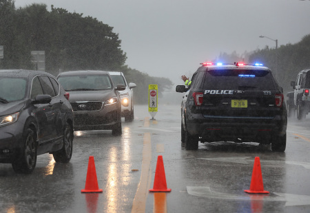 A Highland Beach police officer sits in his vehicle to check id's of people in cars as he only allows residents to enter the Highland Beach area as Hurricane Dorian continues to make its way toward the Florida coast on September 02, 2019 in Highland Beach, Florida. 