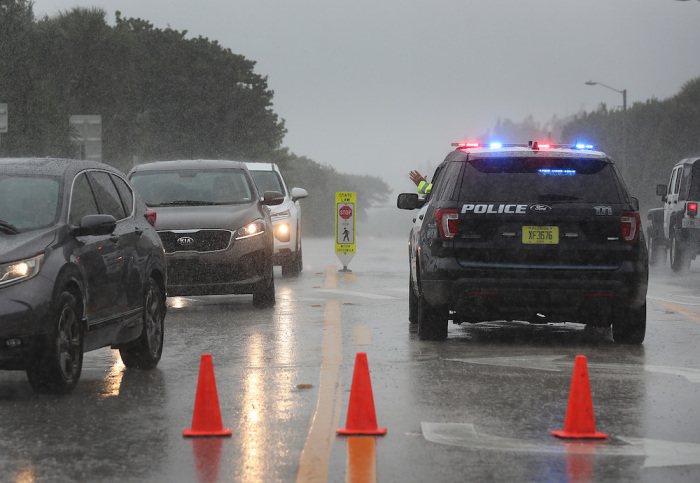 A Highland Beach police officer sits in his vehicle to check id's of people in cars as he only allows residents to enter the Highland Beach area as Hurricane Dorian continues to make its way toward the Florida coast on September 02, 2019 in Highland Beach, Florida. 