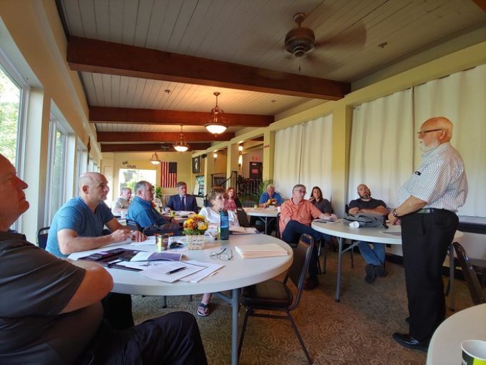 Bill Graham shares an informational packet on suicide prevention competencies for faith leaders at a meeting with churches, ministry, and community leaders in Clarksville, Tenn.