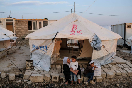 A grandmother from the Syrian town of Al Hasakah with her grandchildren settle with other Syrian refugees who are fleeing the Turkish incursion in Rojava, arrive at Badarash IDPs camp as more than 800 were welcomed to the facility on October 17, 2019, in Dohuk, Iraq. More than 1,000 refugees have arrived in Northern Iraq since the beginning of the conflict, with many saying they paid to be smuggled through the Syrian border. 