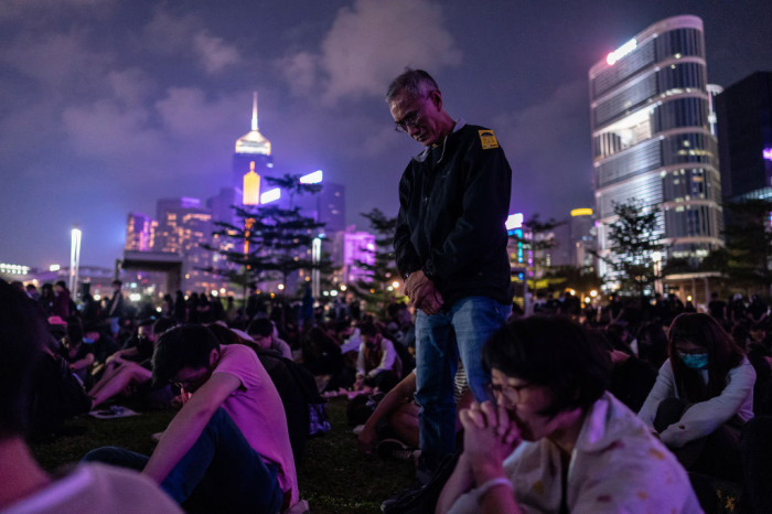 People take a moment of silence during a remembrance prayer in memory of an university student Alex Chow who succumbed to head injuries sustained during a fall as police skirmished with demonstrators last weekend. Photo taken on November 9, 2019, in Hong Kong, China. 