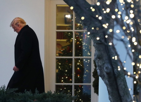 U.S. President Donald Trump walks out of the Oval Office prior to his departure for a campaign event in Battle Creek, Michigan, December 18, 2019 at the White House in Washington, DC. 