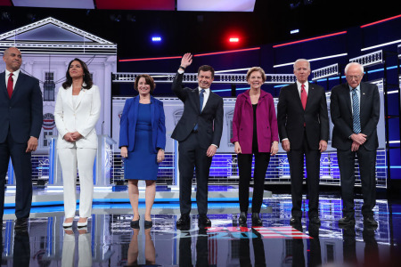 Democratic presidential candidates (L-R) Sen. Cory Booker (D-N.J.), Rep. Tulsi Gabbard (D-Hawaii), Sen. Amy Klobuchar (D-Minn.), South Bend, Indiana Mayor Pete Buttigieg, Sen. Elizabeth Warren (D-Mass.), former Vice President Joe Biden, and Sen. Bernie Sanders (I-Vt.), arrive on stage before the start of the Democratic Presidential Debate at Tyler Perry Studios November 20, 2019, in Atlanta, Georgia. 