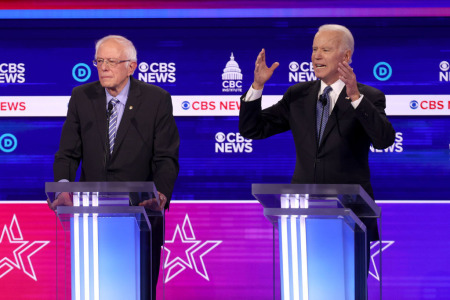 Democratic presidential candidate former Vice President Joe Biden speaks as Sen. Bernie Sanders (I-Vt.) (L) looks on during the Democratic presidential primary debate at the Charleston Gaillard Center on February 25, 2020, in Charleston, South Carolina. 