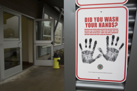 A sign reminding people to wash their hands is pictured outside a dormitory at the Washington State Patrol Fire Training Academy which has been designated as a 2019 novel coronavirus quarantine site for travelers from Hubei Province, China who have been exposed, are not yet symptomatic and cannot self-quarantine, February 6, 2020 in North Bend, Washington. 