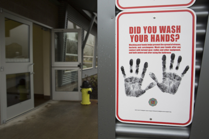 A sign reminding people to wash their hands is pictured outside a dormitory at the Washington State Patrol Fire Training Academy which has been designated as a 2019 novel coronavirus quarantine site for travelers from Hubei Province, China who have been exposed, are not yet symptomatic and cannot self-quarantine, February 6, 2020 in North Bend, Washington. 