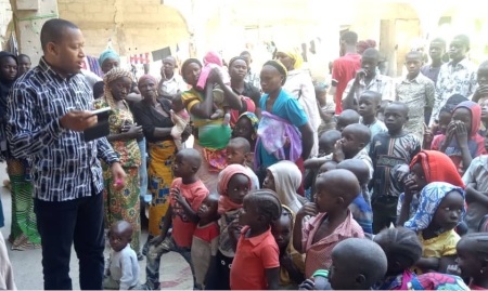 Father Joseph Bature Fidelis (L), the director of psychosocial support and trauma care in the Diocese of Maiduguri, Nigeria, speaks to people within his care.