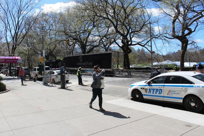 A New Yorker takes pictures at the entrance of the Samaritan's Purse 68-bed field hospital in Central Park's East Meadow along 5 Avenue near Mount Sinai Hospital.