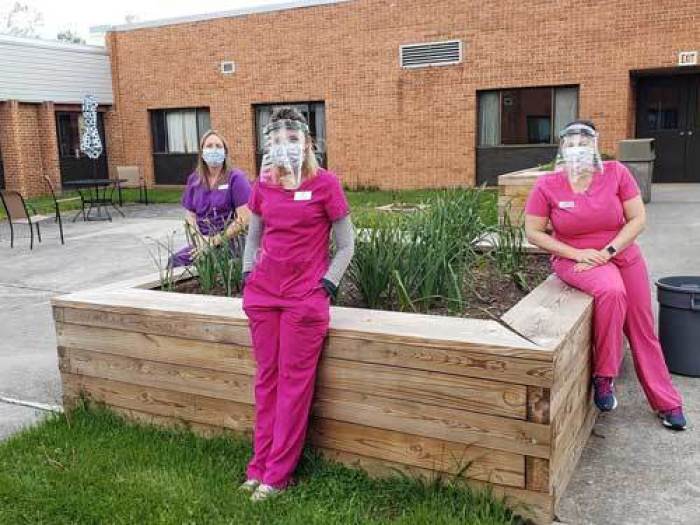 Nurses wearing masks and shields by Sky View Missionary Baptist Church. 