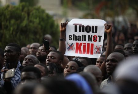 Christians hold signs as they march on the streets of Abuja during a prayer and penance for peace and security in Nigeria in Abuja on March 1, 2020. The Catholic Bishops of Nigeria gathered faithfuls as well as other Christians and other people to pray for security and to denounce the barbaric killings of Christians by the Boko Haram insurgents and the incessant cases of kidnapping for ransom in Nigeria. 