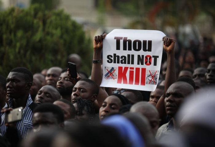 Christians faithfuls hold signs as they march on the streets of Abuja during a prayer and penance for peace and security in Nigeria in Abuja on March 1, 2020. The Catholic Bishops of Nigeria gathered faithfuls as well as other Christians and other people to pray for security and to denounce the barbaric killings of Christians by the Boko Haram insurgents and the incessant cases of kidnapping for ransom in Nigeria. 