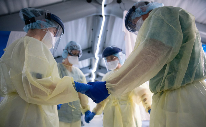 Samaritan's Purse medial team in prayer at a a field hospital in Cremona, Italy, 2020. 