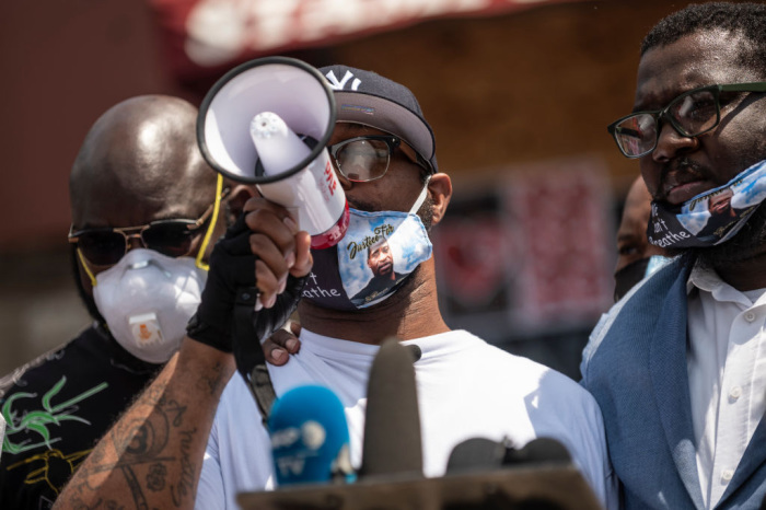 Terrence Floyd (C) speaks to a group gathered at the site where his brother George Floyd was killed by police one week ago on June 1, 2020, in Minneapolis, Minnesota. Floyd called for peace and justice after his brother's death, thanking those who continue to protest and imploring people to cease the damage and destruction which has followed. 