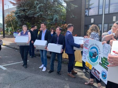 Members of Informed Parents of Washington drop off signatures petitioning for a referendum against recent sex-ed legislation in Olympia, Washington this week.