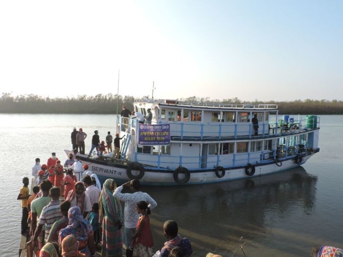 Aid workers with the Believers Eastern Church distribute relief items to residents of Kankandighi island in West Bengal impacted by Cyclone Amphan in June 2020.