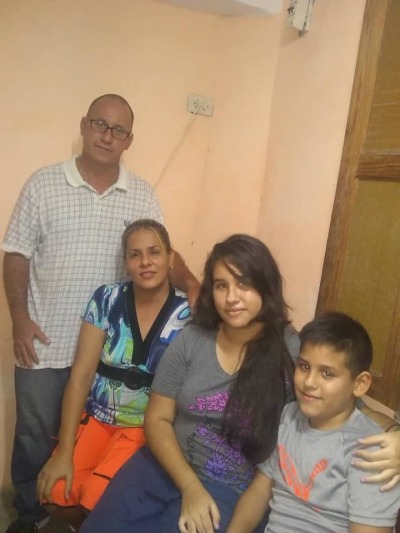 Ramon Rigal (far-left) and Adya Expósito Leyva (center-left) pose with their children.