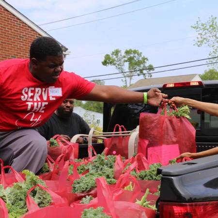 A volunteer distributes food at I5 City Church in Glen Burnie, Md.