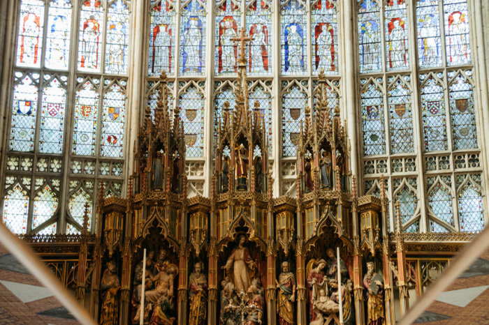 The high altar and great east window of the Gloucester Cathedral reflected into a looking mirror. 