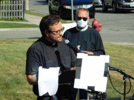 Pastor Jonathan Barker welcomes the crowd and guest speakers at Grace Lutheran Church Kenosha, Wis. 