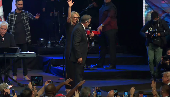 Senior Associate Pastor Denise Goulet and attendees stretch out their hands to pray for President Donald Trump at International Church of Las Vegas, Oct. 18, 2020.