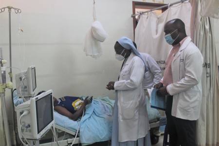 Dr. Sister Priscilla Busingye, president of the Association of Obstetricians and Gynecologists of Uganda, visits a patient.