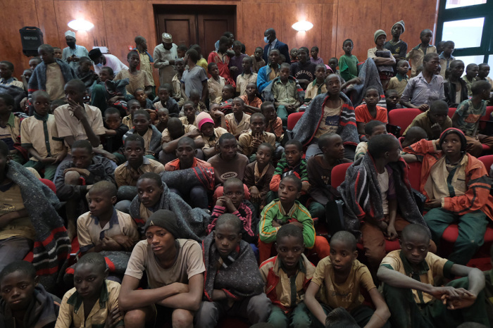 Released students gather at the Government House with other students from the Government Science Secondary school, in Kankara, in northwestern Katsina State, Nigeria, upon their release on December 18, 2020. More than 300 Nigerian schoolboys were released on Thursday after being abducted in an attack claimed by Boko Haram, officials said, although it was unclear if any more remained with their captors. 