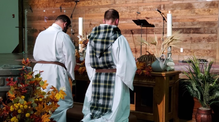 The Reverend Travis Ewton (left) kneels next to Rev. Matt Scraper (right) during the Order of St. Patrick's Allhallowtide retreat held Nov. 5-7. Novitiate members who had completed at least one year of discernment and training were invited to take vows to become official members of the order. Those who were not ready to take vows were invited to continue the discernment process for another year. 