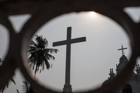 A cross is captured through some ornamental railings in the Fort Kochi area in the state of Kerala in South India.