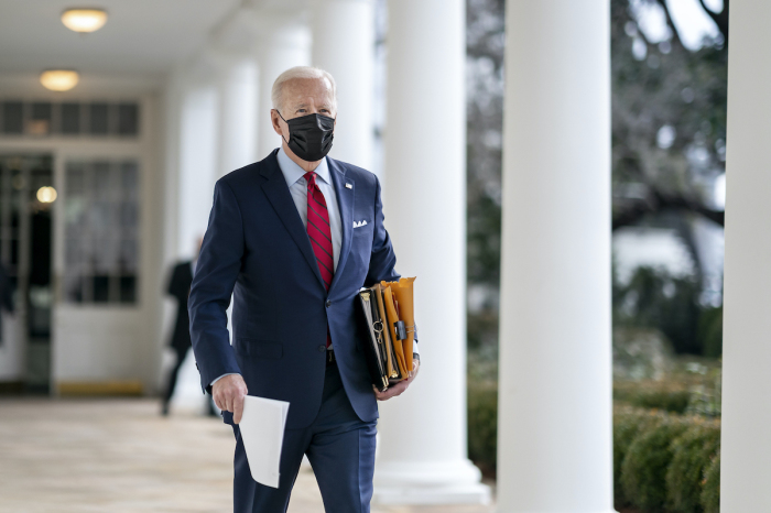 President Joe Biden walks along the Colonnade of the White House Thursday, Jan. 28, 2021, en route to the Oval Office. 