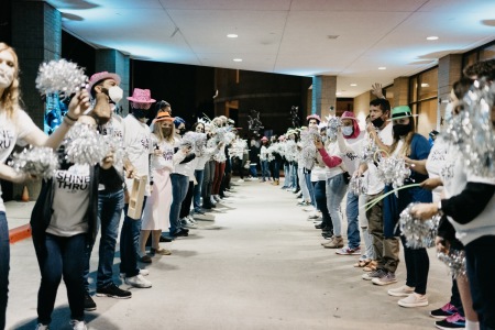 Volunteers cheer on participants in the Shine-Thru prom experience. 