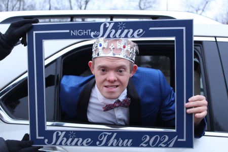 A Night to Shine-Thru individual wears a crown during the drive-thru event. 