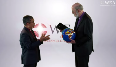 Outgoing Secretary-General Bishopp Efraim Tendero (left) hands over a globe and a Bible to incoming Secretary-General Bishop Thomas Schirrmacher during a handover ceremony in Bonn, Germany on Feb. 27, 2020. 