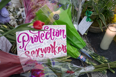 A sign sits at the memorial outside of The Gold Spa it reads 'Protection for Asian, immigrant, and all sex workers' on March 19, 2021, in Atlanta, Georgia. Mourners have gathered to pay their respects after suspect Robert Aaron Long, 21, attacked three spas killing eight people, six of whom were Asian, two of whom were white. 