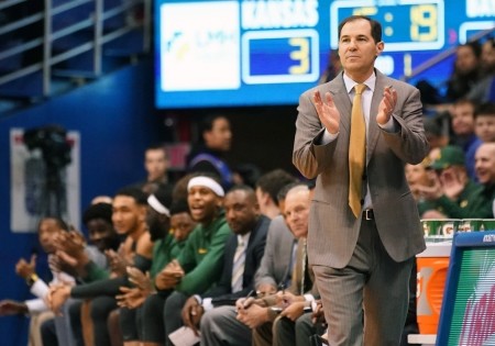 Baylor University men's basketball coach Scott Drew claps his hands in approval during a game against the University of Kansas. The Baylor men's basketball program won its first NCAA championship on April 5, 2021.