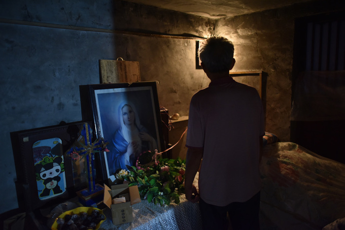 A man stands in a room in a house church in Puyang, in China's central Henan province on August 13, 2018. 