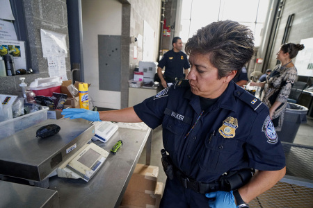 An Immigration and Customs Enforcement (ICE) agent weighs a package of Fentanyl at the San Ysidro Port of Entry on October 2, 2019, in San Ysidro, California. - Fentanyl, a powerful painkiller approved by the U.S. Food and Drug Administration for a range of conditions, has been central to the American opioid crisis which began in the late 1990s. China was the first country to manufacture deadly illegal fentanyl for the U.S. market, but the problem surged when trafficking through Mexico began around 2005. 